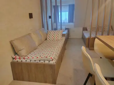 a living room with a couch and a table at Apartmani Iva Kop Konaci Koznik402 in Kopaonik