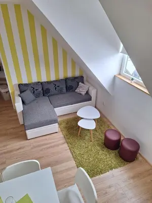 a small living room with a couch and a table at Apartman R&M Kraljevi čardaci in Kopaonik