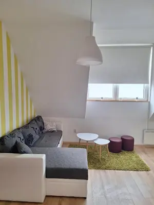 a living room with a couch and a table at Apartman R&M Kraljevi čardaci in Kopaonik
