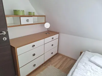 a bedroom with a dresser and a bed at Apartman R&M Kraljevi čardaci in Kopaonik