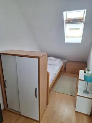 a small bedroom with a bed and a window at Apartman R&M Kraljevi čardaci in Kopaonik