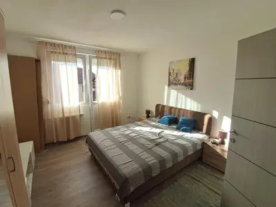 a bedroom with a bed with blue pillows on it at La pera Kruševac in Kruševac