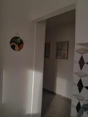 a hallway with a wall with a clock on the wall at La pera Kruševac in Kruševac