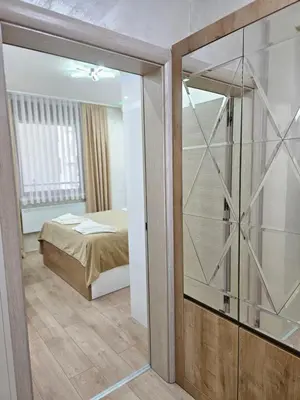 a bedroom with a bed and a sliding glass door at Exclusive apartmants 1 Vrnjacka Banja in Vrnjačka Banja
