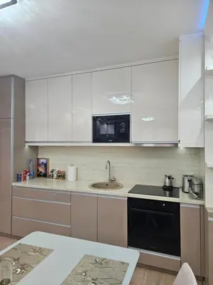 a kitchen with white cabinets and a sink at Exclusive apartmants 1 Vrnjacka Banja in Vrnjačka Banja