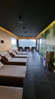 a row of beds in a room with the ocean at Lux Apartman Kop Zoned in Kopaonik