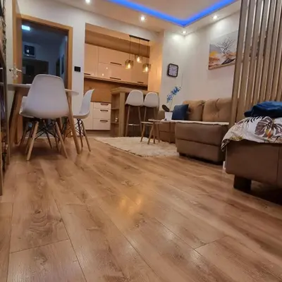 a living room with a table and a couch at Lux Apartman Kop Zoned in Kopaonik