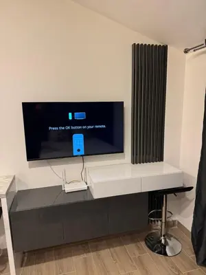 a flat screen tv on a wall in a room at Residence Hill Kopaonik in Kopaonik