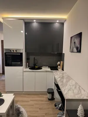 a kitchen with white cabinets and a counter top at Residence Hill Kopaonik in Kopaonik