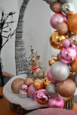 a table with a bunch of ornaments and a christmas tree at Apartman Dunja in Kraljevo