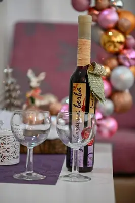 a bottle of wine and two glasses on a table at Apartman Dunja in Kraljevo