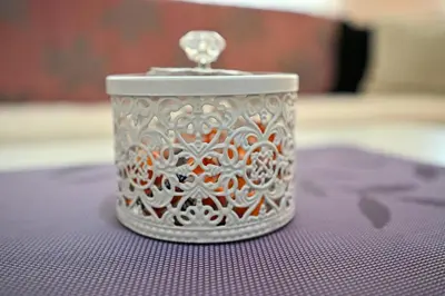 a silver candle holder sitting on top of a table at Apartman Dunja in Kraljevo