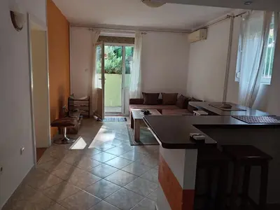 a living room with a couch and a table in a room at Apartman Ilić in Vrnjačka Banja