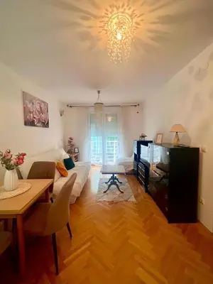 a living room with a couch and a table at Asami in Vrnjačka Banja