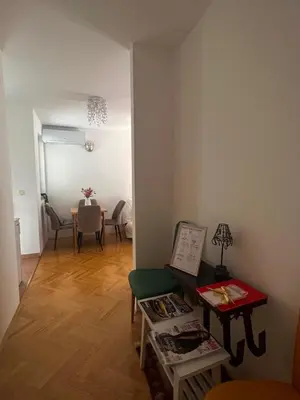 a living room with a table and a dining room at Asami in Vrnjačka Banja
