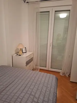 a bedroom with a bed and a window at Asami in Vrnjačka Banja
