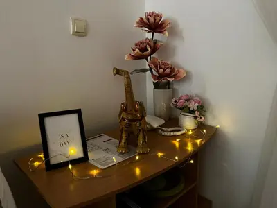 a table with a picture and lights on it at Asami in Vrnjačka Banja