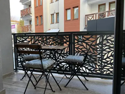 a balcony with a table and chairs on a balcony at Vila Elena in Kopaonik