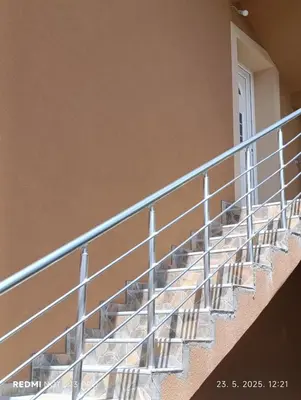 a balcony with metal stairs in a building at Garfield Family Studio 1 in Soko Banja