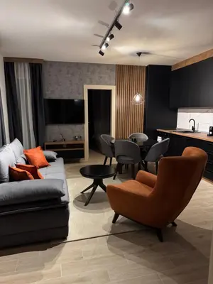 a living room with a couch and a table at Friends Lux apartment Kopaonik in Kopaonik