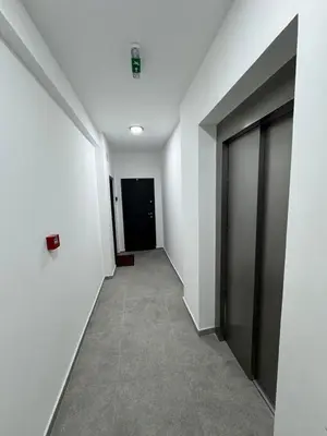 a hallway with white walls and a black door at Friends Lux apartment Kopaonik in Kopaonik