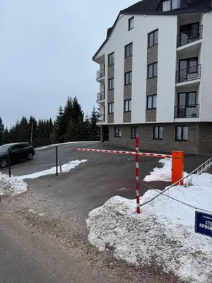 a parking lot in front of a building at Friends Lux apartment Kopaonik in Kopaonik