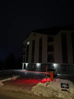 a building at night with red lights in front of it at Friends Lux apartment Kopaonik in Kopaonik