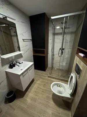 a bathroom with a shower and a toilet and a sink at Friends Lux apartment Kopaonik in Kopaonik