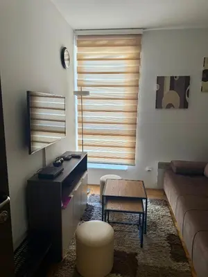 a living room with a desk and a couch at Apartman Filipovic - Kraljevi Cardaci - Kopaonik in Kopaonik