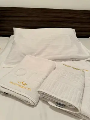 two white towels sitting on top of a bed at Apartman Filipovic - Kraljevi Cardaci - Kopaonik in Kopaonik