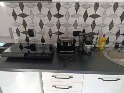 a kitchen counter with a blender and a sink at Garfield Family Studio 2 in Soko Banja