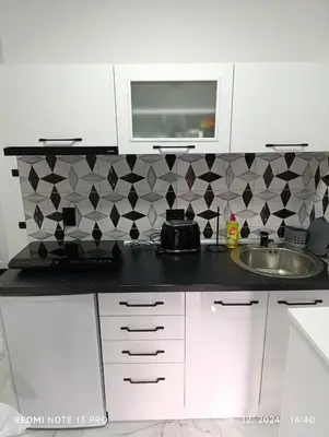 a kitchen counter with a sink and a microwave at Garfield Family Studio 2 in Soko Banja