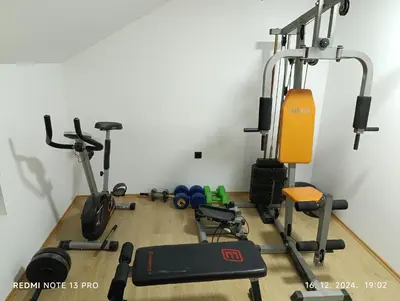 a gym with several exercise equipment in a room at Garfield Family Studio 2 in Soko Banja