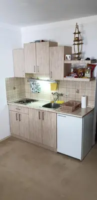 a kitchen with wooden cabinets and a sink at Vila Yeti Kopaonik in Kopaonik