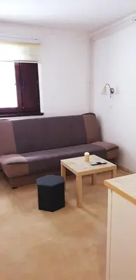 a living room with a couch and a coffee table at Vila Yeti Kopaonik in Kopaonik