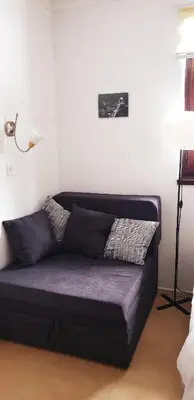 a black couch sitting in a room with a lamp at Vila Yeti Kopaonik in Kopaonik