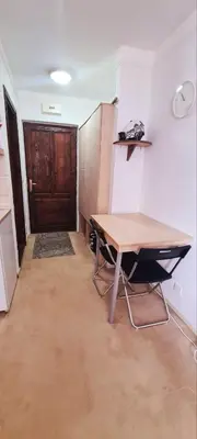 a room with a table and a wooden door at Vila Yeti Kopaonik in Kopaonik