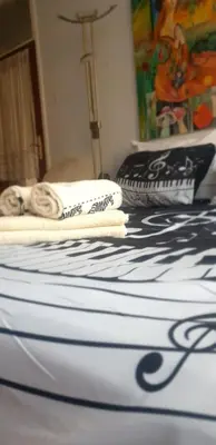 a bed with two towels on top of it at Smart 2 in Niš