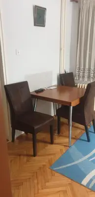 a dining room table with two chairs and a table at Smart 2 in Niš