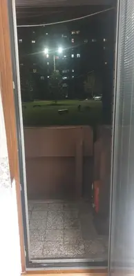 a sliding glass door with a view of a park at Smart 2 in Niš