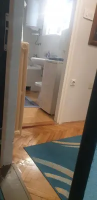 a bathroom with a sink and a blue rug at Smart 2 in Niš