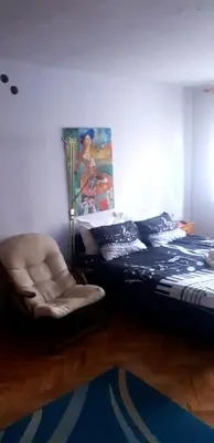 a bedroom with a bed and a chair at Smart 2 in Niš