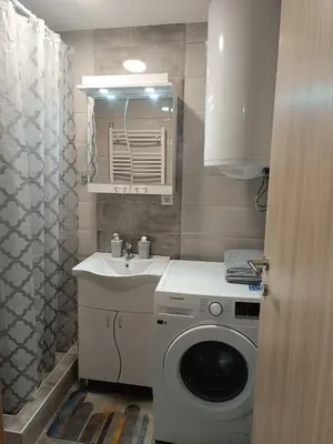 a bathroom with a washing machine and a sink at Luksuzni Apartman Ema 2 in Pirot