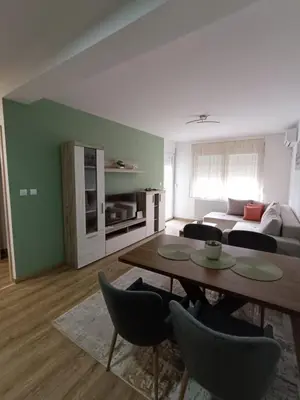 a living room with a table and a couch at Luksuzni Apartman Ema 2 in Pirot