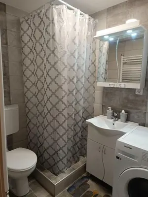 a bathroom with a toilet and a sink and a shower at Luksuzni Apartman Ema 2 in Pirot