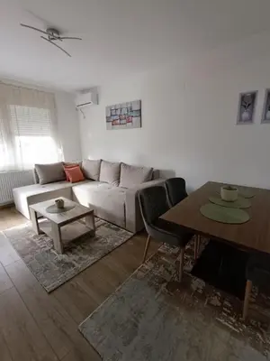 a living room with a couch and a table at Luksuzni Apartman Ema 2 in Pirot