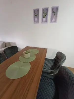 a dining room table with two chairs and a bowl on it at Luksuzni Apartman Ema 2 in Pirot
