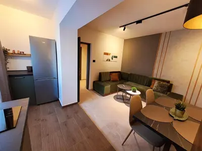 a living room with a couch and a table at HILL Lux Apartman 1, FREE Secure private yard PARKING 2 place, DESIGNER home & WI-FI rooms & SMART TVx3 & 2 Bedroom & Rooms & Apartments Nis in Niš