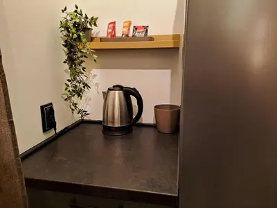 a tea kettle sitting on a counter in a room at HILL Lux Apartman 1, FREE Secure private yard PARKING 2 place, DESIGNER home & WI-FI rooms & SMART TVx3 & 2 Bedroom & Rooms & Apartments Nis in Niš
