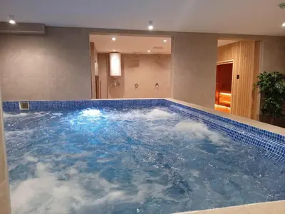 a large pool of water with clouds in it at NORD VISTA Premium Alpine and SPA Experience in Kopaonik